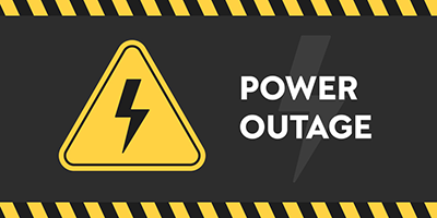 Yellow triangle on a black background with a lightning bolt and text, "Power Outage."