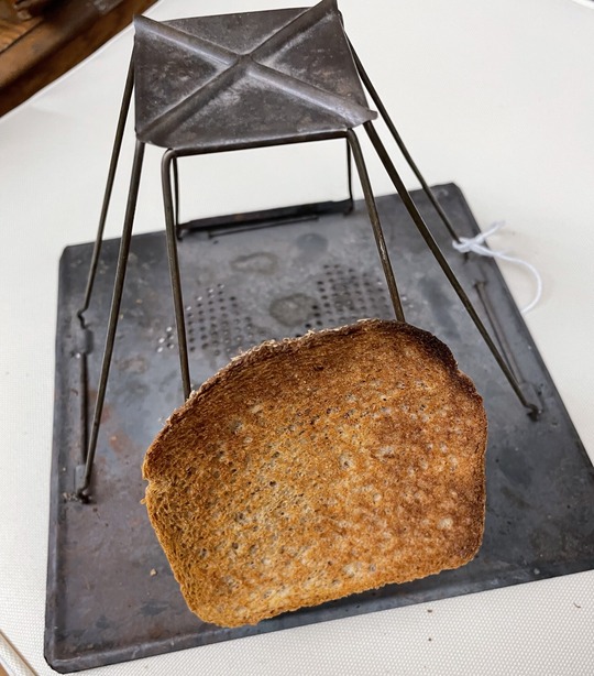 A piece of toast on the historic toaster.