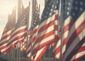 American flags on metal poles during golden hour