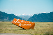 Brown Superior, Colorado sign in front of mountain backdrop and blue sky