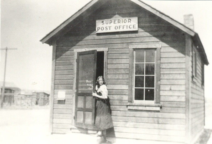 Woman standing in the doorway of the historic Superior post office.