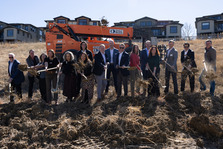Kite Route Crossing groundbreaking with people symbolically tossing dirt.
