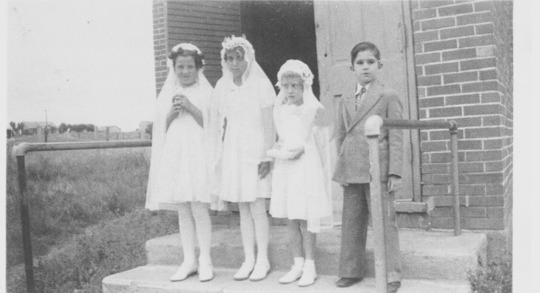 Helen Malczyk, Helen Sekulich, Marie Machin and George Kupfner pose for their first Communion at St. Benedicts in the 1940's.