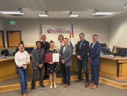 Superior Town Council Members and the President of the Coal Creek Meals on Wheels board pose with a proclamation document in council chambers