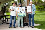 Dave Sutherland, Phary Om, and Peter Ruprecht pose with Bird City Colorado sign