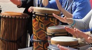 Hands play drums in a circle