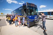 Riders board an RTD bus