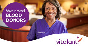 Woman in purple smiling with text "we need blood donors"