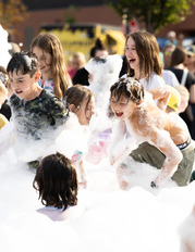 A group of children play in bubbles 