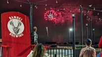 Colorful red fireworks can be seen from the patio at Bambei Brewing