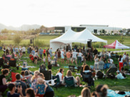 A crowd sits in blankets and chairs during the Summer Concert Series in Superior