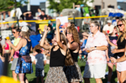 People clapping along to a Summer Concert.
