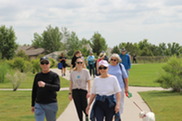 People walk together at the park during Walk with a Doc