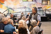 A man smiles at a community event for Superior Seniors