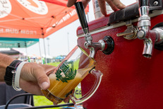 Beer being poured into a Beer Fest mug.