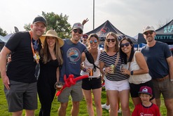 Friends posing with their beer fest mugs.