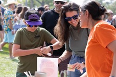 Person smiling while receiving chili.