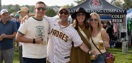 Friends posing with their Beer Fest mugs during the Chili & Beer Fest.