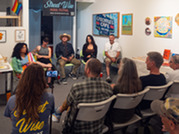 A crowd gathers for an artist talk during a past mural festival 