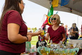 Person receiving a drink during the 2025 Chili & Beer Fest.
