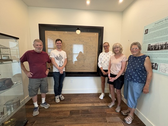 Historical Commission Members standing inf front of the newly framed Drumm's Map.