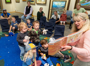Librarian Reading book to children 