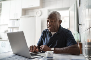 Older man working on a laptop