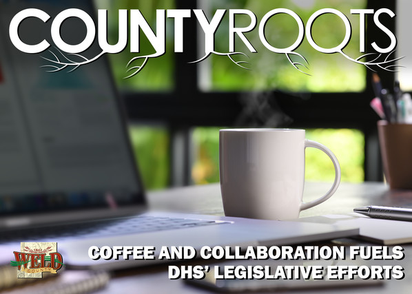 A steaming cup of coffee by a computer