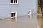 Flood water rising to windows of a building