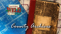 A book of county records. Text reads "county archives
