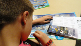 A child working on an activity during the weather spotter training