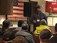 Josh Holbrook speaking at a conference.