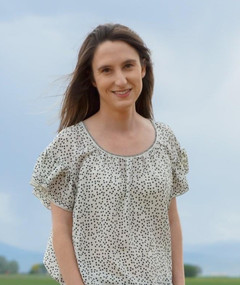 Shaley Dehner smiling in a cornfield.