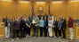 Members of Weld County's child support team standing with the Weld County Board of Commissioners.