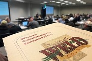 A booklet with the Weld County logo. Text reads: "Whole community immersion." People in the background. 
