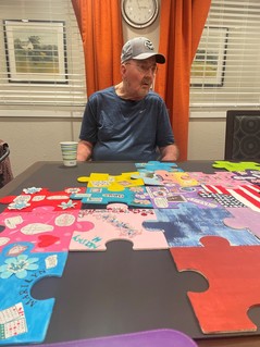 Long-term care resident Kenton sitting at a table speaking on the value of the resident council meetings.