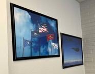 Pictures on the wall of the American and military flags as well as a fighter jet.