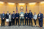 Members of Eaton's FFA horse judging team standing with the Weld County Board of Commissioners.