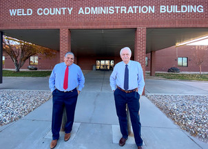 Steve Moreno and Don Warden standing outside the Weld County Administration Building.