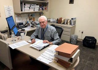 Don Warden sitting at his desk. 