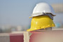 Hardhats sitting on a construction barrier.