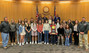 The Eaton High School softball team standing with the Weld County Board of Commissioners,