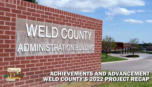 The sign outside the Weld County Administration Building with the parking lot in the background.