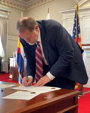 Commissioner James signs his oath of office.