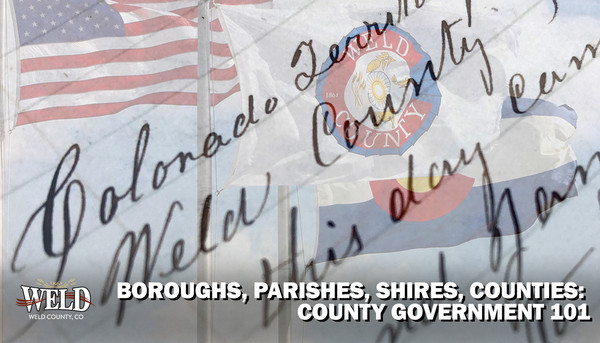 An old document that says Colorado Territory, Weld County, along with the American flag, Colorado flag and Weld County flag.