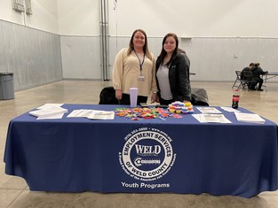 Members of Employment Services of Weld County smiling at a table.