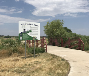 A sign standing at the entry of the Weld Legacy Trail.