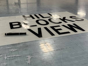A finished sign reading "hill blocks view."