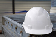 A hard hat sitting on construction equipment.