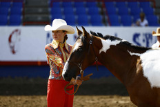 A girl showing a horse.